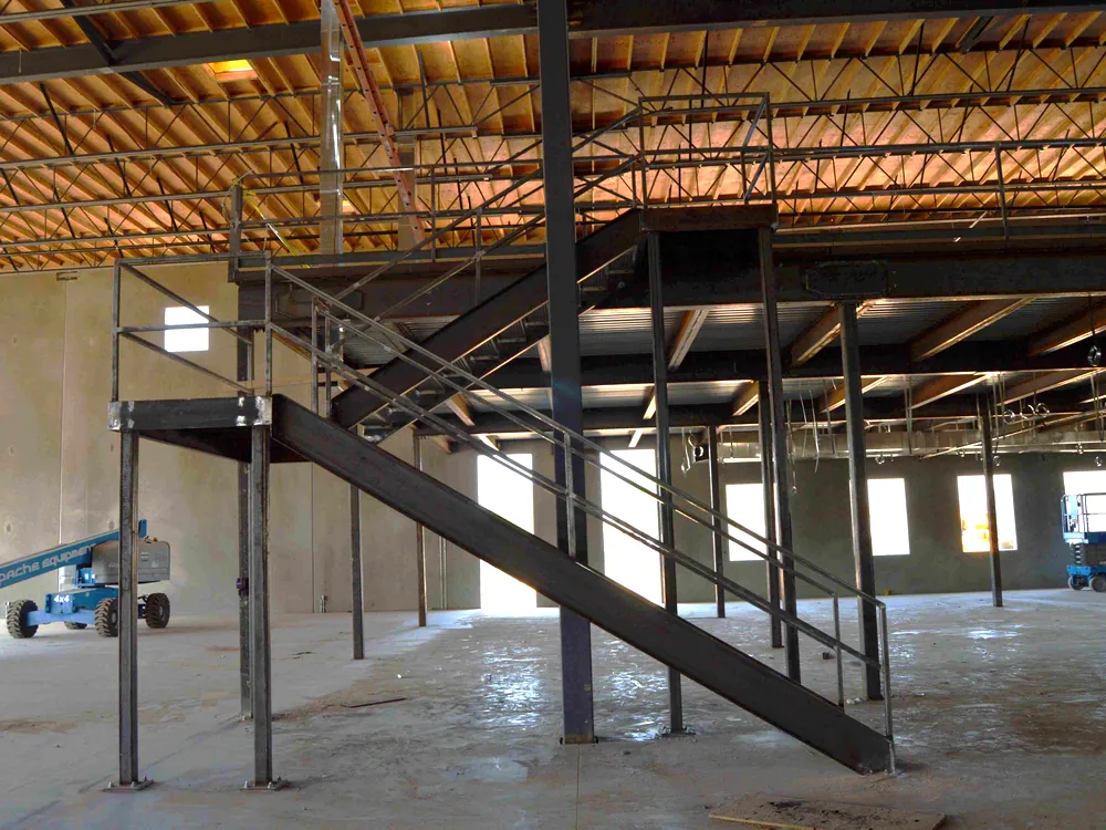 Structural steel building mezzanine with stair